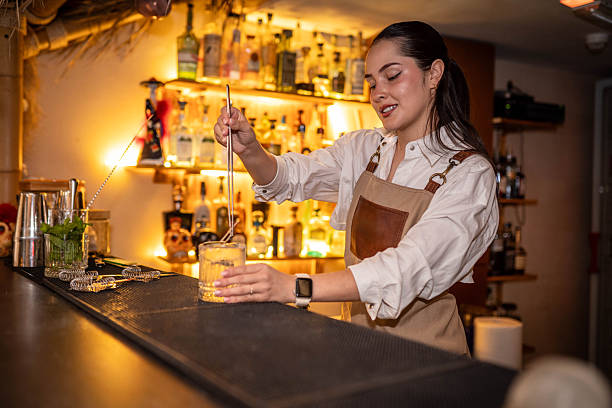 istock Female bartender preparing a cocktail in a traditional cocktail bar 2240097280