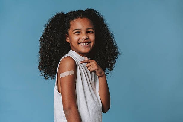 istock Proud child showing arm with bandage after vaccination in studio 2240099796