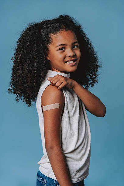 istock Proud child showing arm with bandage after vaccination in studio 2240099797