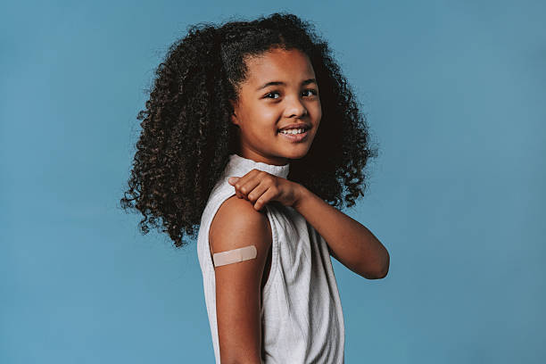 istock Proud child showing arm with bandage after vaccination in studio 2240099799