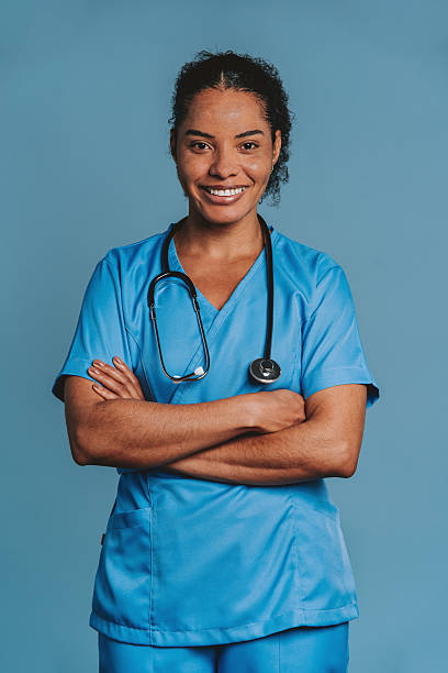 istock Friendly nurse smiling with arms crossed in studio 2240099845
