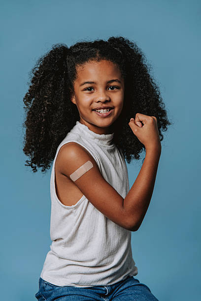 istock Brave child showing strength after vaccination in studio 2240099927