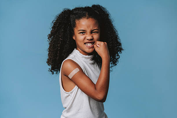 istock Brave child showing strength after vaccination in studio 2240099998
