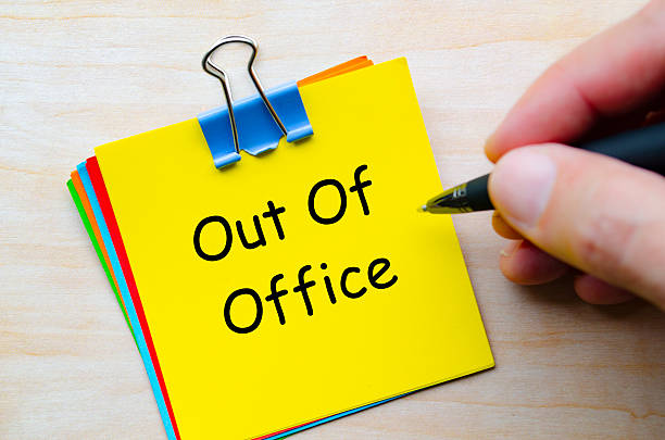 istock Out Of Office text on stack of multicolored notepads. 2240101400