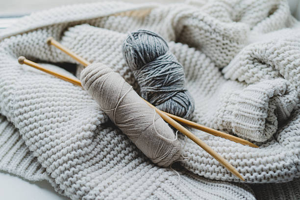 istock Knitting materials and soft yarn on a cozy blanket in a warm indoor setting 2240101726
