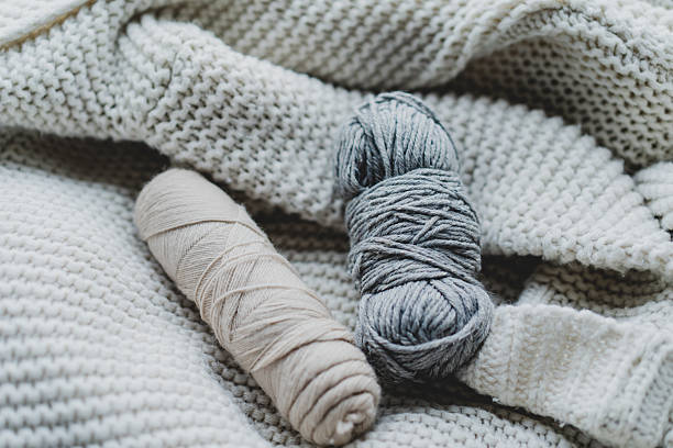 istock Knitting materials and soft yarn on a cozy blanket in a warm indoor setting 2240101785