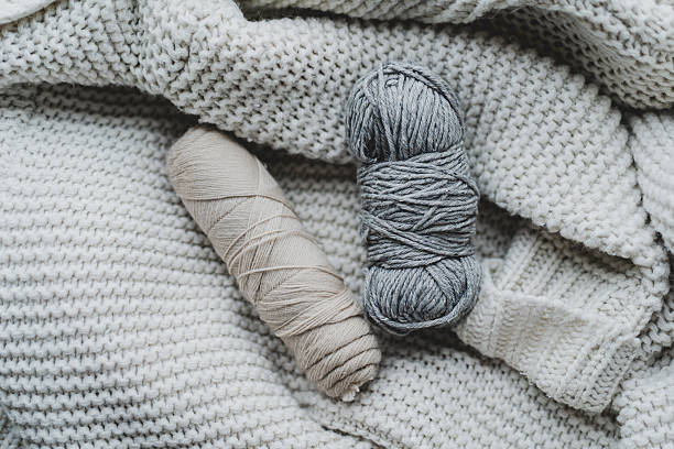 istock Knitting materials and soft yarn on a cozy blanket in a warm indoor setting 2240101788