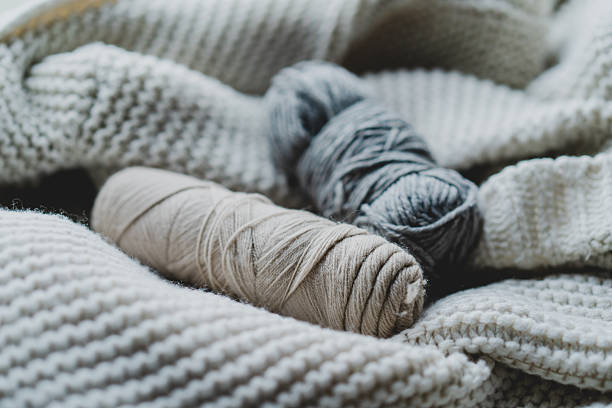 istock Knitting materials and soft yarn on a cozy blanket in a warm indoor setting 2240101802