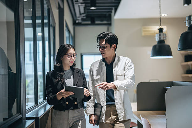 istock Businessperson brainstorming sessions and presentations with her team 2240103599