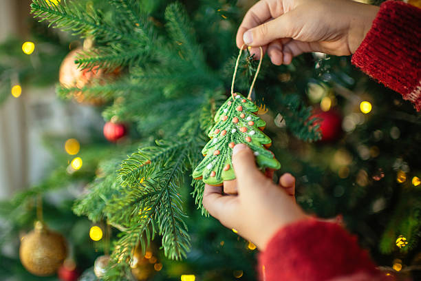 istock Child decorating Christmas tree with gingerbread cookies 2240104466