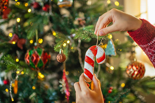 istock Child decorating Christmas tree with gingerbread cookies 2240104495