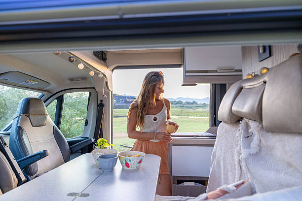 istock Woman Enjoying Drink Inside Camper Van 2240104769