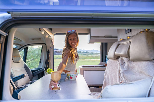 istock Woman Relaxing Inside Camper Van at Sunset 2240104826