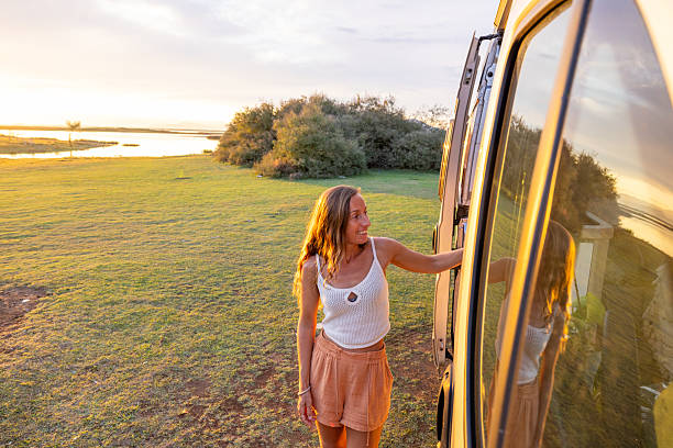 istock Woman Opening Camper Van Door at Sunset 2240105059