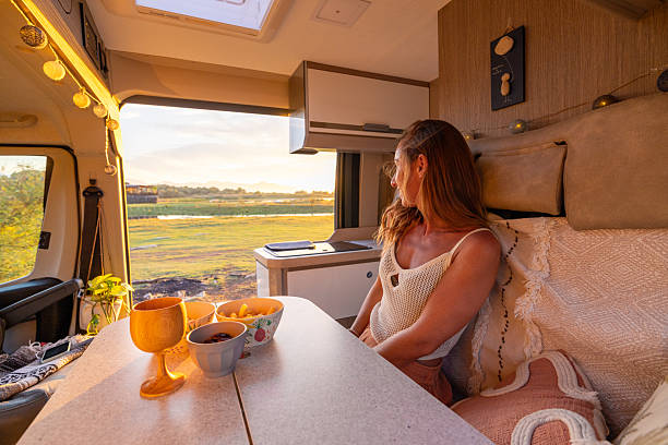 istock Woman Enjoying Sunset View Inside Campervan 2240105099