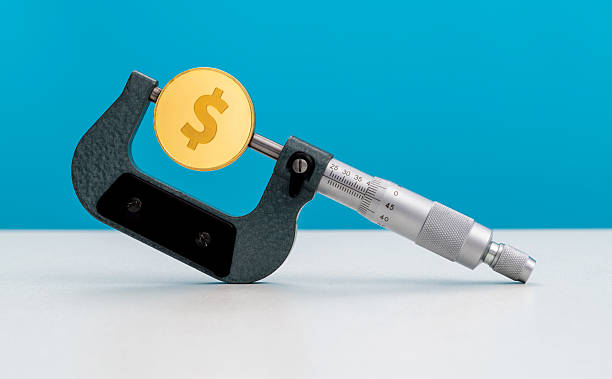 istock Micrometer with a dollar sign coin 2240105707