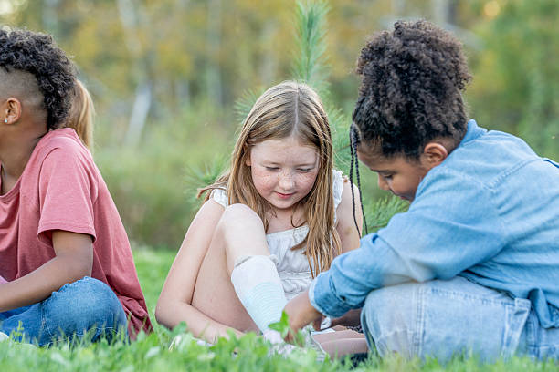 istock Diverse Group Of Kids Sitting On Grass Outdoors, Exploring And Laughing Together 2240108337