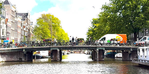 Amsterdam, Netherlands - 5 August 2025: Enjoy a tranquil boat ride through Amsterdam's canals, passing under quaint bridges.
