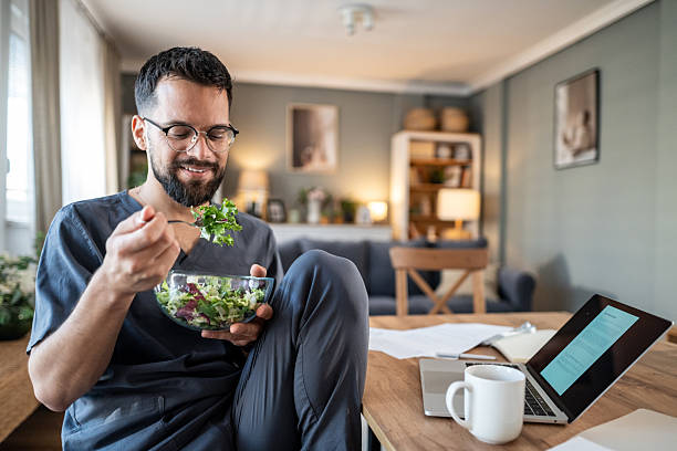 istock Male professional eating healthy salad during remote work lunch break 2240110478