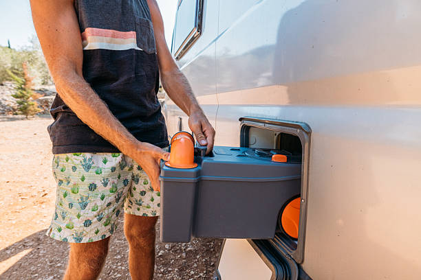 istock Person  Installing Portable Toilet in Camper Storage 2240110788
