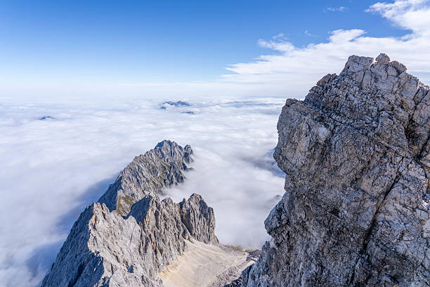 istock Undercast Clouds with a Rocky Ridgeline exposed from Zugspitze Highest Peak in Germany 2240110795