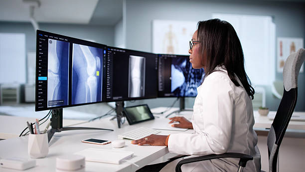 istock Skilled African American Doctor Examines Knee X-ray Before 2240114119