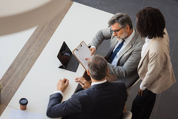 Business colleagues reviewing contract documents in office meeting