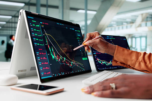 istock Analyzing Online Financial Graphs, A Professional Woman Trades 2240115273