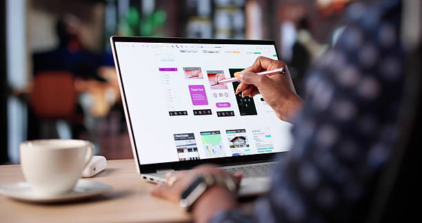 istock Black Businesswoman Designs User Interface On Laptop 2240115313