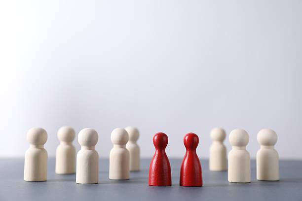 istock Human resources concept. Red figures among wooden ones on table against light background, closeup. Space for text 2240117564