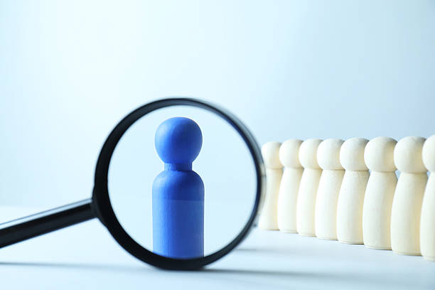 istock Human resources concept. Looking at blue figure through magnifying glass on light background, closeup 2240117674