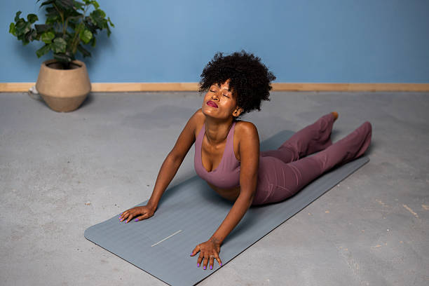 istock Woman practicing yoga cobra pose for wellness 2240117879
