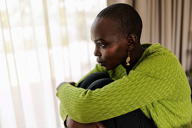 istock Thoughtful Black Woman Sitting by the Window 2240119082