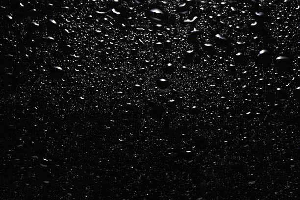 istock Water drops on black glass surface, top view 2240121529