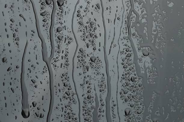 istock Water drops on grey glass surface, closeup 2240121550