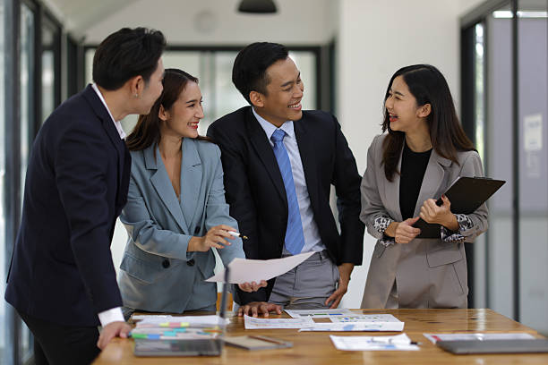 istock Coworkers standing and talking in the office. 2240122694