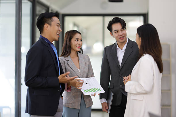 istock Coworkers standing and talking in the office. 2240123338