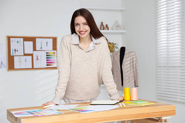 istock Fashion designer working at wooden table in workshop 2240123500
