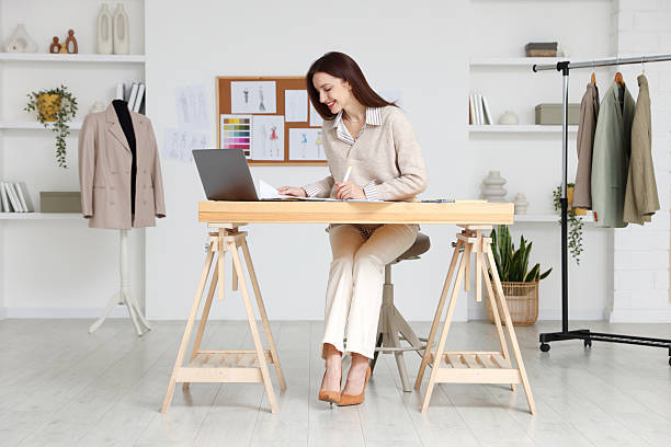 istock Fashion designer working at wooden table in workshop 2240123702