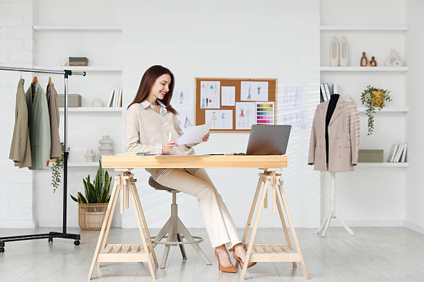 istock Fashion designer working at wooden table in workshop 2240123799