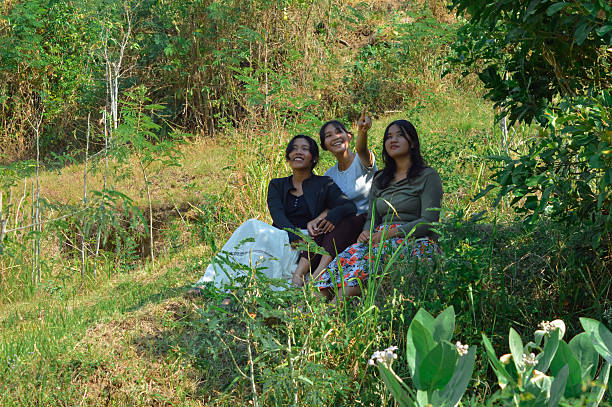 istock Three teenage girls pointing and observing something while sitting 2240124944
