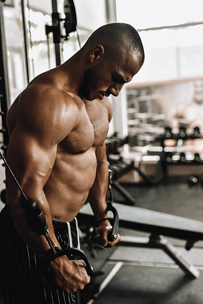 istock Male Bodybuilder Demonstrating Intense Arm Curl Workout With Cable Machine In Gym 2240125381