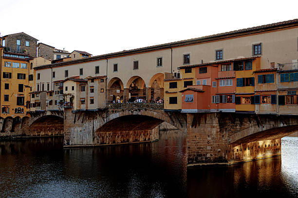 A scenic view of the Ponte Vecchio medieval stone bridge in Florence, Italy.