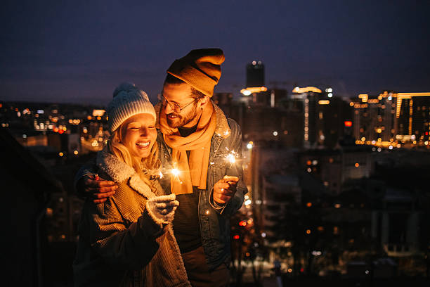 istock Romantic Winter Moment with Sparklers on Rooftop 2240127951