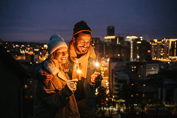 istock Happy Couple Celebrating Outdoors with Sparklers 2240127957