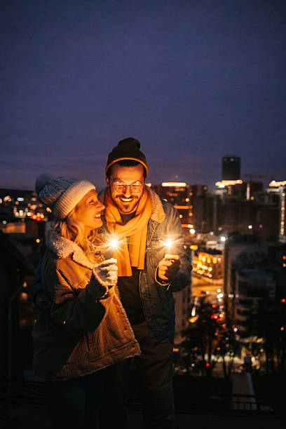 istock Romantic Winter Moment with Sparklers on Rooftop 2240127959