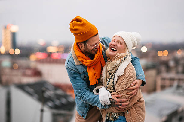 istock Happy Young Couple Laughing Together Outdoors in Winter 2240128005