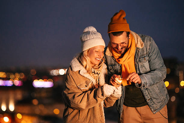 istock Igniting Festive Sparklers at Night with City Lights in Background 2240128026