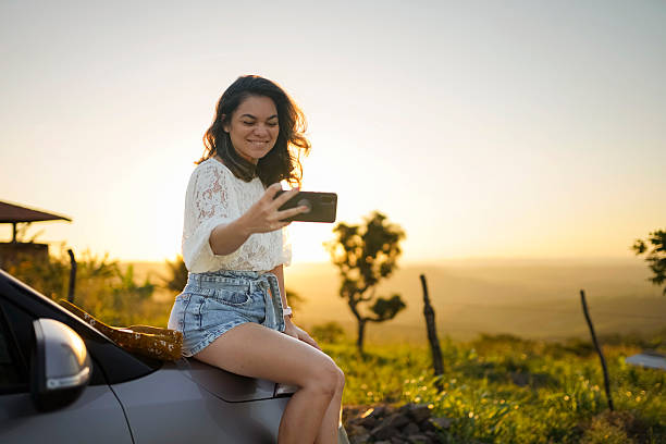istock Woman taking a selfie at sunset in nature 2240129493