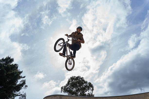 istock Man performing bmx stunt in a skate park, jumping high 2240130678